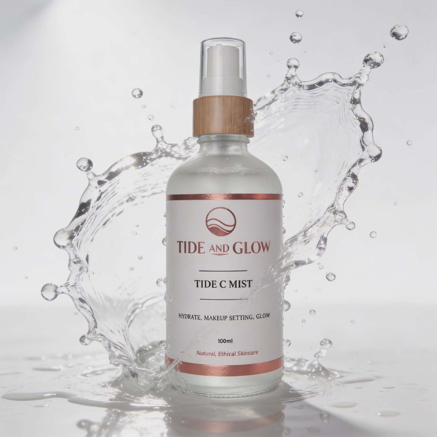 Tide and Glow Tide C Mist bottle with water splash on a light gray background