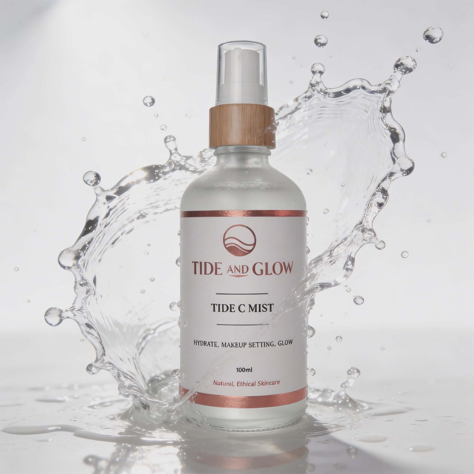 Tide and Glow Tide C Mist bottle with water splash on a light gray background